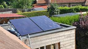 A solar panel on a roof
Description automatically generated